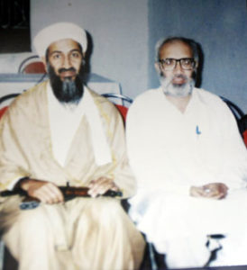 Journalist Rahimullah Yusufzai (right) sits with Osama bin Laden for a photo after conducting an interview with the infamous militant in Afghanistan in 1998.