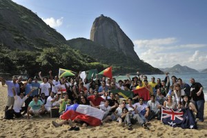 Red Bull Tum Tum PÃ¡ teams pose for photo at Praia Vermelha in front of the Sugarloaf mountain in Rio de Janeiro.