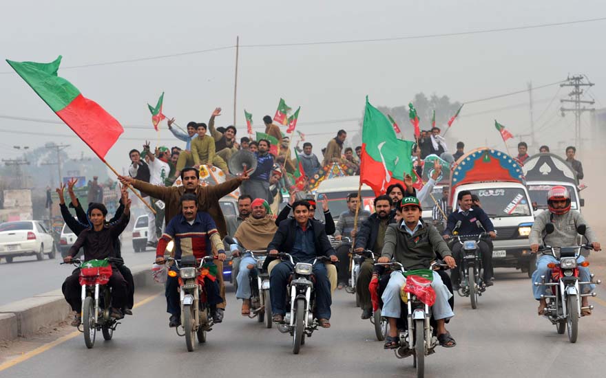 Activists of Pakistan Tehreek-e-Insaaf (PTI) arrive to attend a protest rally in Peshawar on November 23, 2013. Thousands of Pakistani activists from right-wing political parties November 23 protested against US drone strikes, threating to block NATO supply routes, if strikes continue. AFP PHOTO/A MAJEED