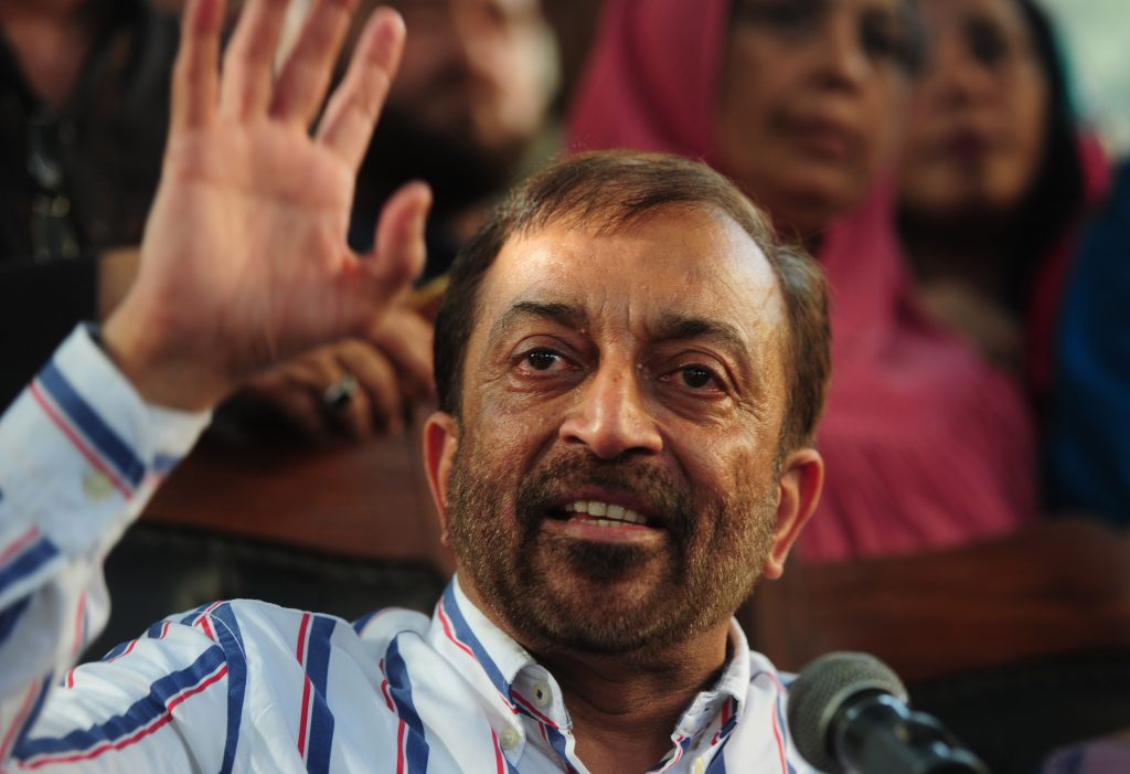 Pakistani Muttahida Qaumi Movement (MQM) political party leader Farooq Sattar gestures as he addresses a press conference in Karachi on August 23, 2016. Pakistani police charged the exiled leader of an influential political party with treason and inciting terrorism, accusing him of provoking violence at a protest a day earlier in Karachi. Altaf Hussain, leader of the Muttahida Qaumi Movement (MQM) which rules Karachi, Pakistan's biggest city, was accused with a dozen other party leaders of raising anti-Pakistan slogans at the demonstration on August 22, 2016. / AFP PHOTO / ASIF HASSAN
