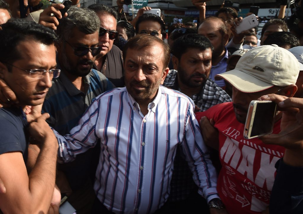 Pakistani Muttahida Qaumi Movement (MQM) political party leader Farooq Sattar (C) arrives for a press conference in Karachi on August 23, 2016. Pakistani police charged the exiled leader of an influential political party with treason and inciting terrorism Tuesday, accusing him of provoking violence at a protest a day earlier in Karachi. Altaf Hussain, leader of the Muttahida Qaumi Movement (MQM) which rules Karachi, Pakistan's biggest city, was accused with a dozen other party leaders of raising anti-Pakistan slogans at the demonstration on August 22, 2016. / AFP PHOTO / ASIF HASSAN