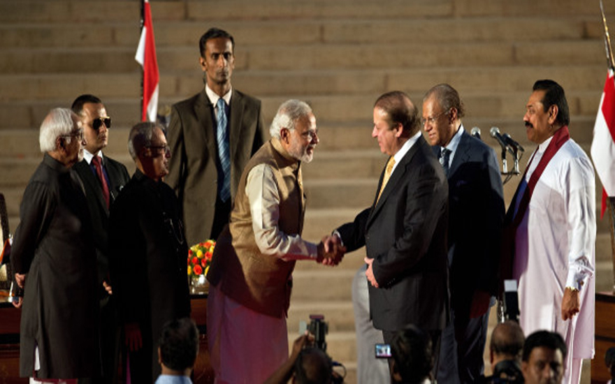 Newly sworn-in Indian Prime Minister Narendra Modi (5th L) shakes hands with Pakistani Prime Minister Nawaz Sharif (3rd R) as Sri Lankan President Mahinda Rajapakse (R) looks on after the swearing-in ceremony at the Presidential Palace in New Delhi on May 26, 2014. India's Narendra Modi was sworn in as prime minister May 26 with the strongest mandate of any leader for 30 years, promising to forge a "strong and inclusive" country on a first day that signalled his bold intentions. AFP PHOTO/Prakash SINGH