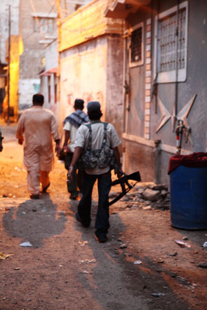 Above the law: Weapons are commonplace in Karachi and are carried openly in the streets.