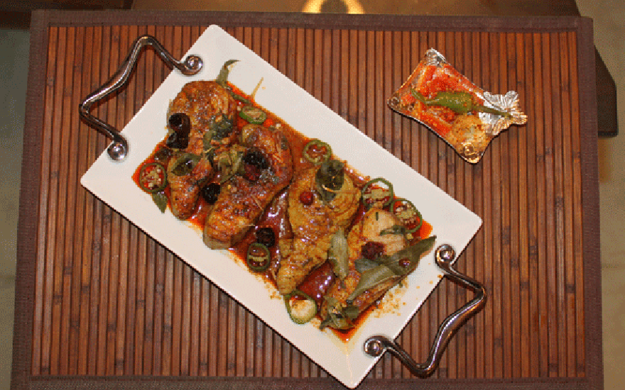 Traditionally Prepared Fish Garnished with Curry leaves and Chillies