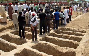The persecution continues: Ahmedi families bury the victims of the May 2010 Lahore attacks.