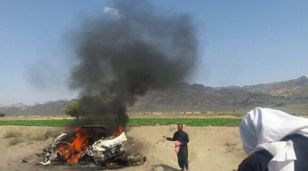 This photograph taken on May 21, 2016 shows Pakistani local residents gathering around a destroyed vehicle hit by a drone strike in which Afghan Taliban Chief Mullah Akhtar Mansour was believed to be travelling in the remote town of Ahmad Wal in Balochistan, around 160 kilometres west of Quetta. Afghan authorities scrambled May 22 to confirm the fate of Taliban leader Mullah Akhtar Mansour after US officials said he was likely killed in drone strikes -- a potential blow to the resurgent militant movement. / AFP PHOTO / -